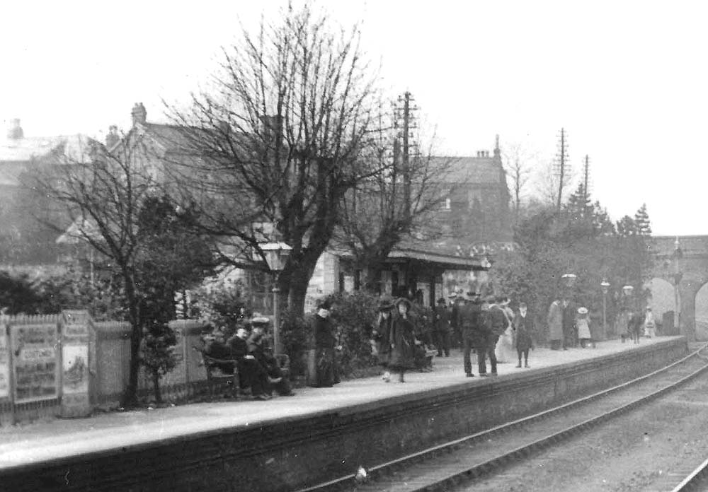 Close up of Acocks Green station's down platform with passengers waiting the arrival of a local service to Birmingham Snow Hill