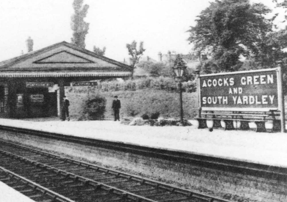 Close up of Acocks Green station's main island platform with the down main platform nearest the camera and the up platform the other side