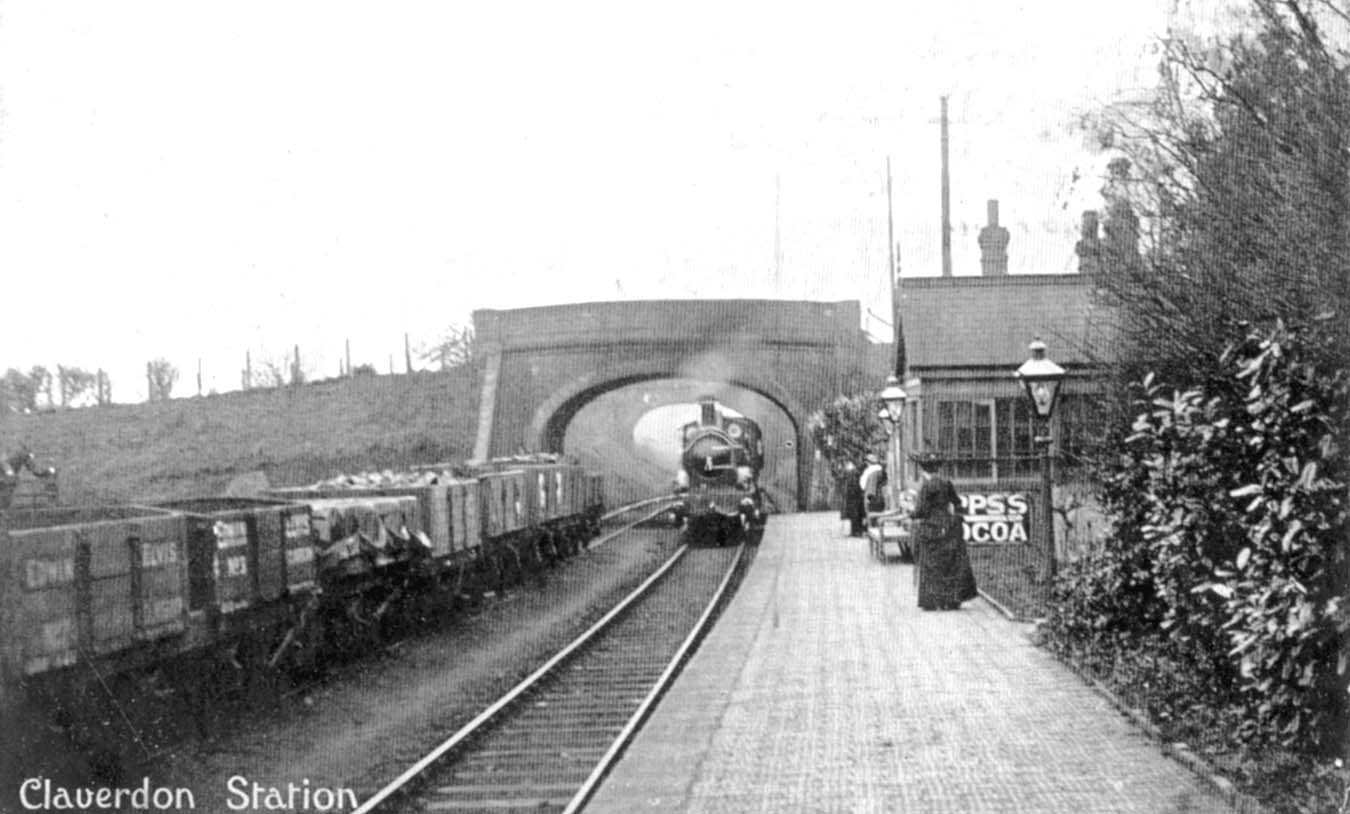 Claverdon station as a train steams under the road bridge at the Bearley end of the station