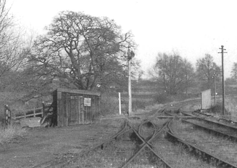 Close up showing the gangers hut at the Bearley end of the yard and the up distance signal protecting Spencers level crossing