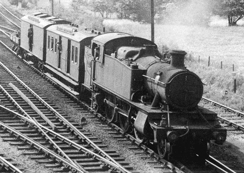 Close up of the Tyseley engineers train headed by GWR 5101 class 2-6-2T Prairie No 5152 with a mess van, tool van and a 3 plank open