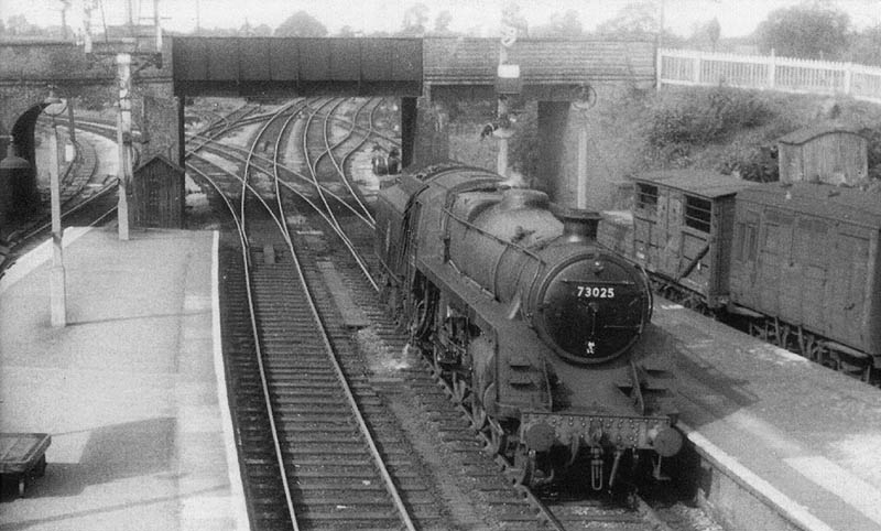 British Railways 4-6-0 Standard Class 5MT No 73025 runs light engine off the Stratford branch onto the up line