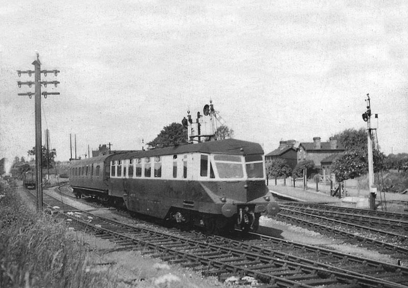 A GWR Railcar with a composite coach in tow departs for Leamington Spa from Hatton station's branch platform