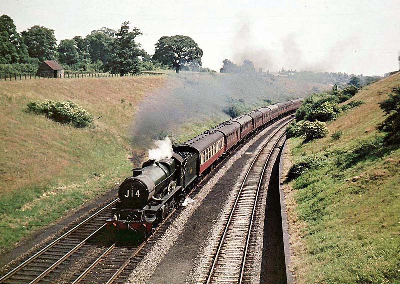 Ex-GWR 60xx Class 4-6-0 No 6018 'King Henry VI' is seen workinga down express on 8th July 1962