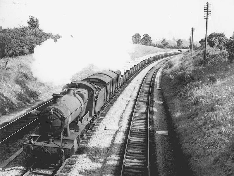 Ex-GWR 2884 class 2-8-0 No 3825 climbs Hatton bank on the down main line with a class C express freight on 7th september 1956