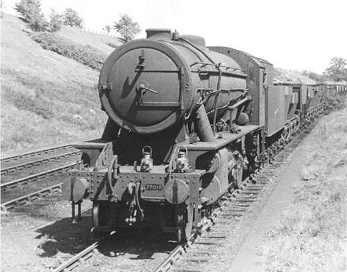 Austerity WD 2-8-0 No 77015 is seen ascending Hatton bank on the goods down line with a class H freight train on 15th May 1948