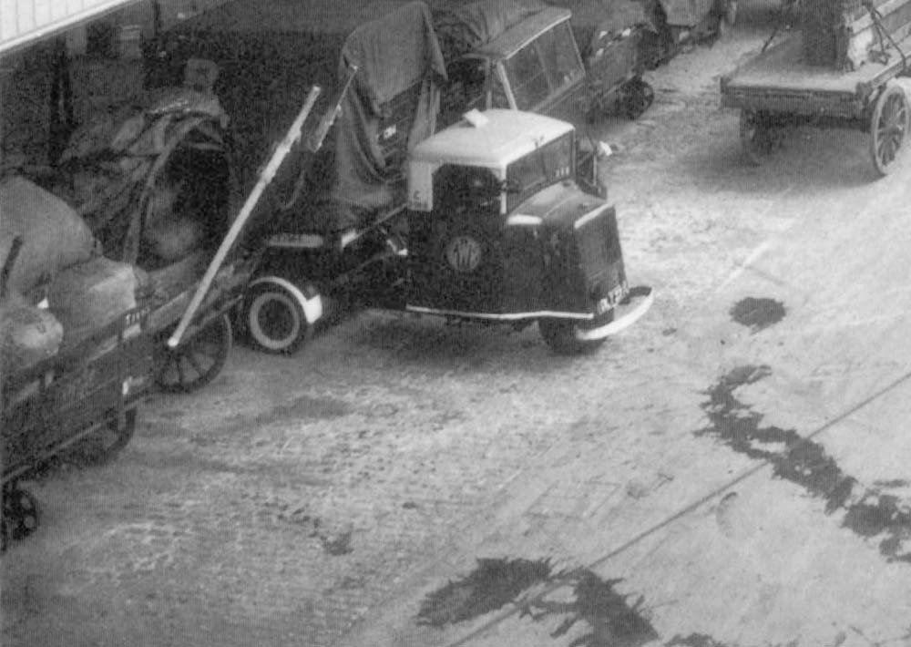 Close up showing a three wheel 'mechanised horse' adjacent to a standard lorry and horse-drawn vehicle