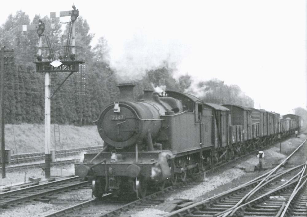 GWR 2-8-2T 72xx class No 7247 is seen entering the station at the head of a short through fast freight train