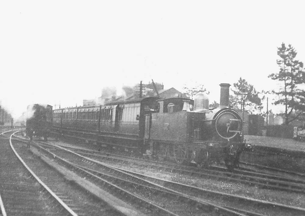 An unknown GWR 2-4-0T 'Metro' class is seen at the head of a local down train comprising six-wheel stock