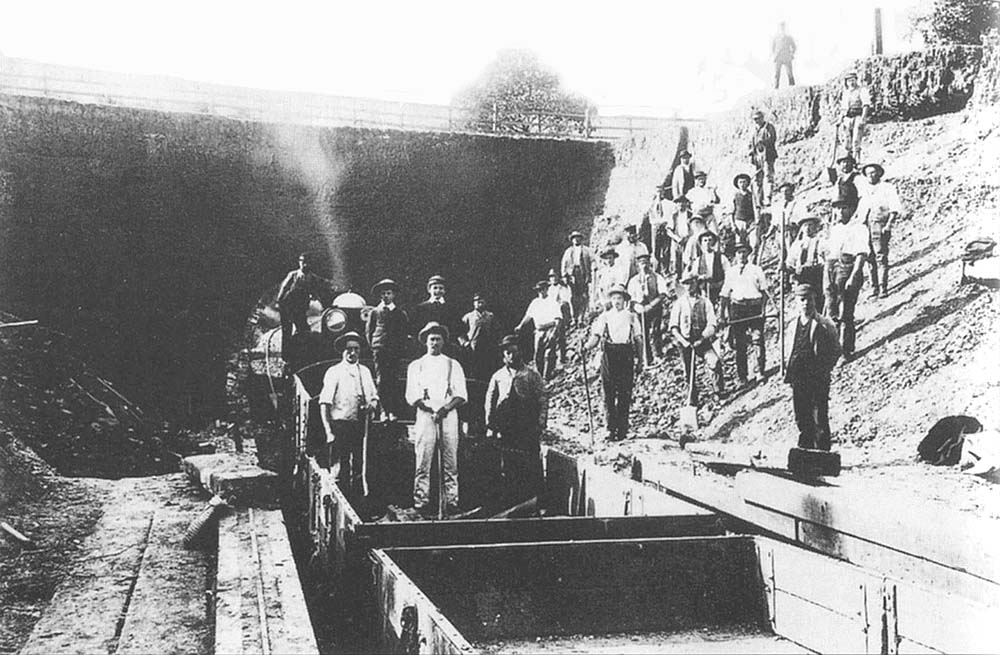 View of the construction crew working on removing the original Moreton-in-Marsh tramway tunnel which passed under Camden Road
