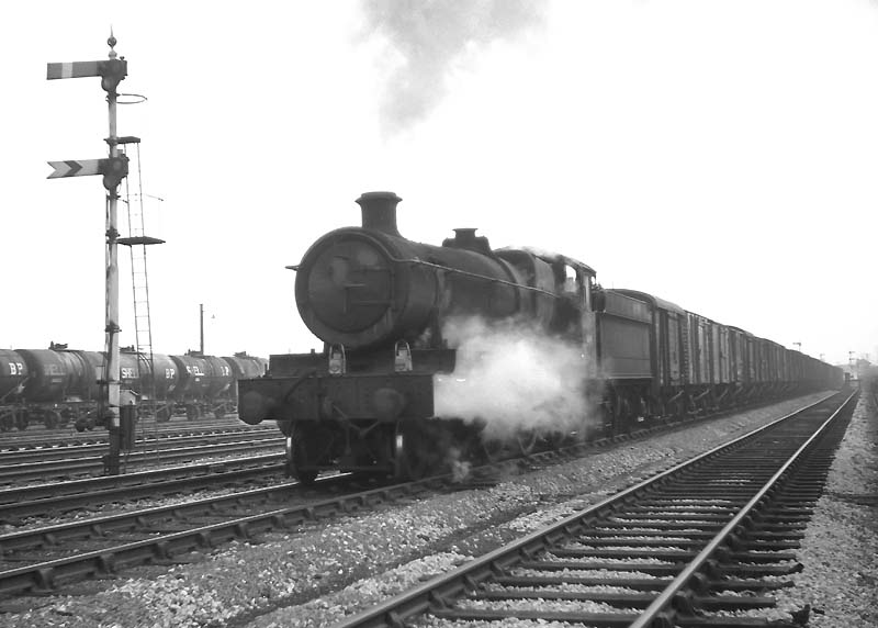 Ex-GWR 68xx Class 4-6-0 No 6864 'Dymock Grange' heads a freight service through Queens Head sidings on 1st May 1965