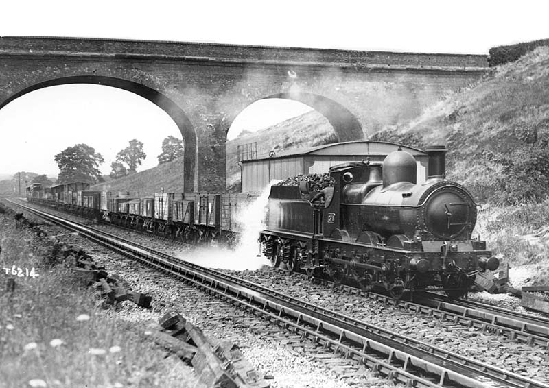Great Western Railway double framed 0-6-0 2361 class No 2378 picking up water at Rowington troughs with a down class H 'through freight' train