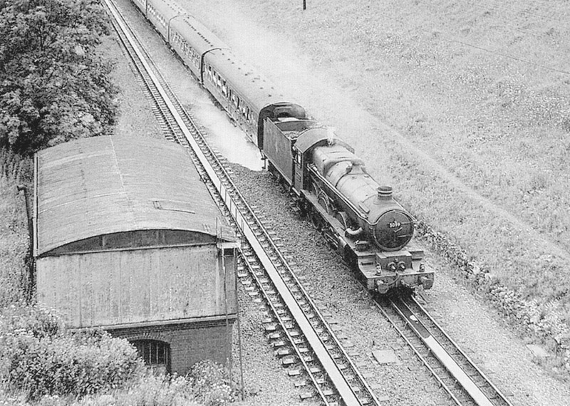 Ex-GWR 4-6-0 No 5099 'Compton Castle' heads the 2:10pm Paddington to Birkenhead as it picks up water on 29th July 1962