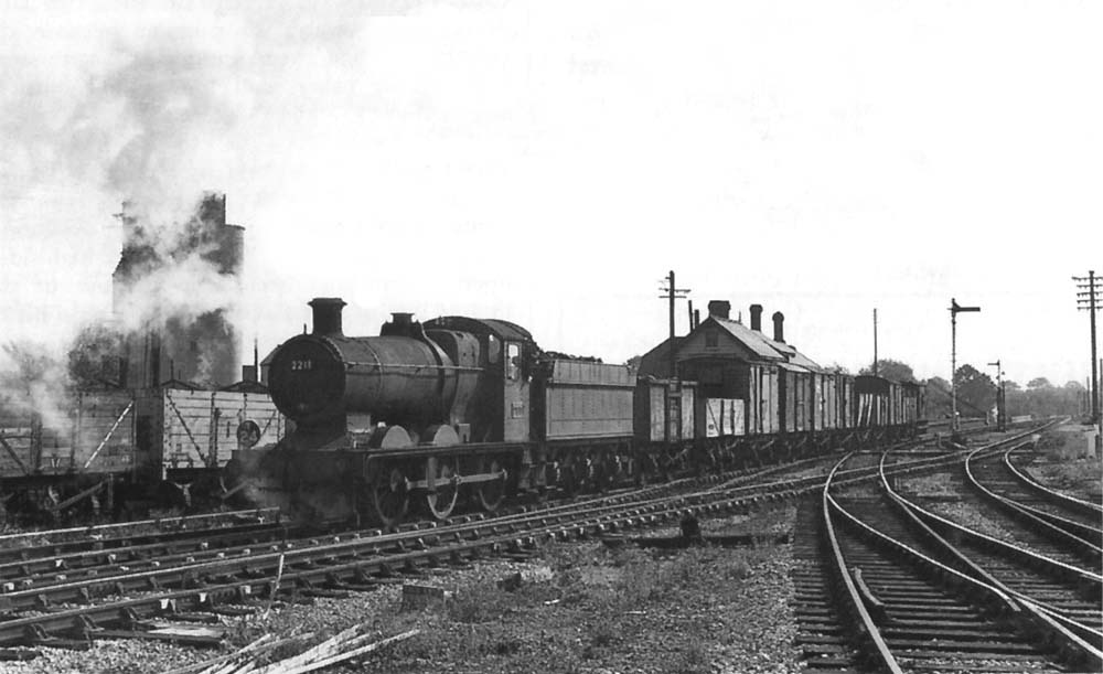 Ex-GWR 0-6-0 2251 class No 2211 is seen at the head of the 'Tiddly Dyke' as it gets ready to leave the former SMJ station via the exchange lines