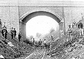 View of the consruction gang bringing the Shipton branch up to standard as they pose beneath the 'New Bridge' carrying Camden Road over the railway