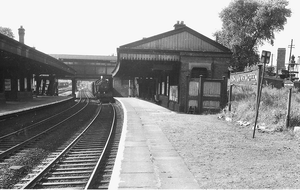 Looking towards Wolverhampton along the Up Main platform as a class C train approaches, circa 1960