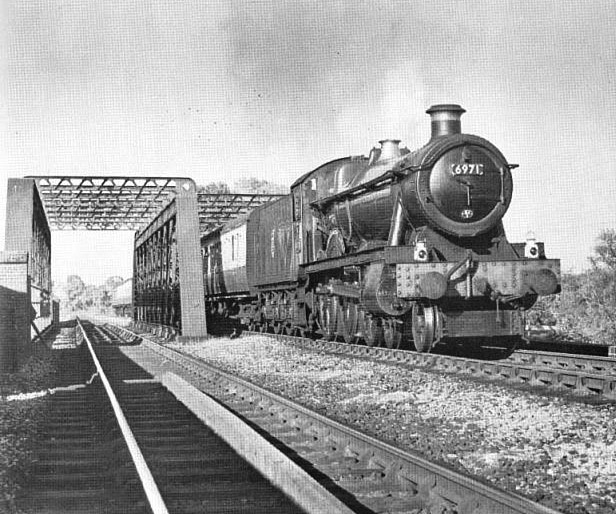 Ex-Great Western Railway 4-6-0 49xx Hall class No 6971 Athelhampton Hall crossing the lattice girder bridge adjacent to Stratford-upon-Avon Racecourse