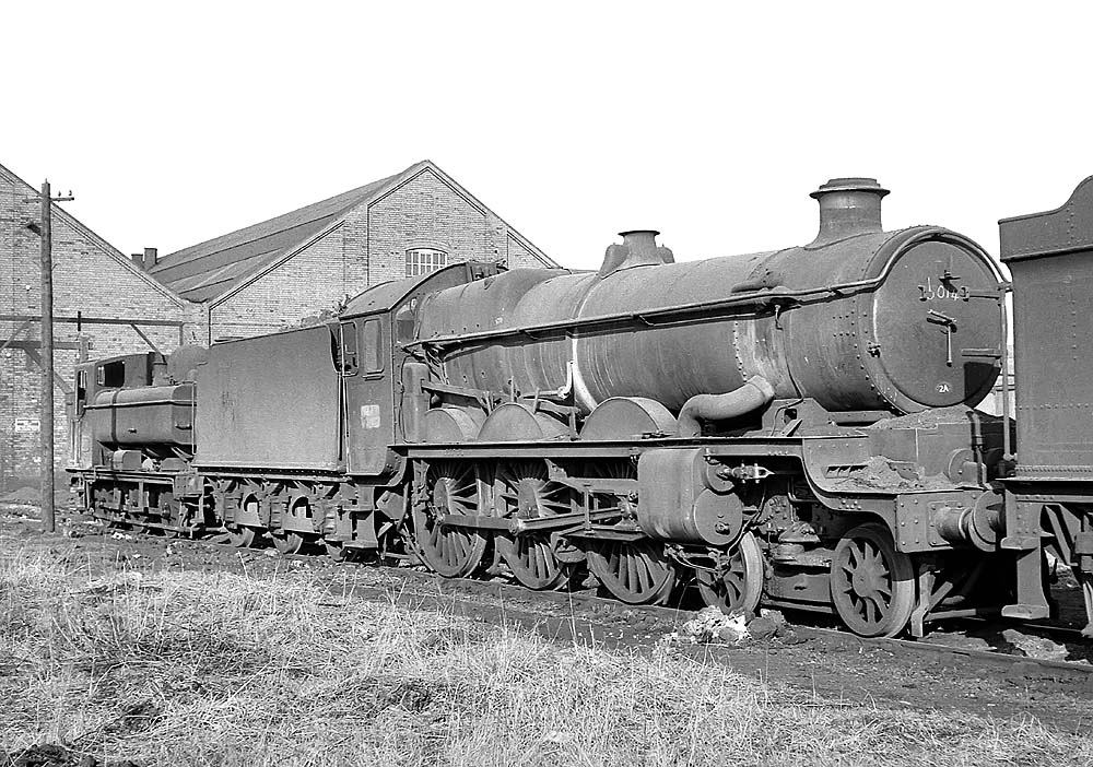 Ex-Great Western Railway 4-6-0 Castle Class No 5014 'Goodrich Castle' is sandwiched between a Castle and an unknown 0-6-0PT locomotive on 31st January 1965