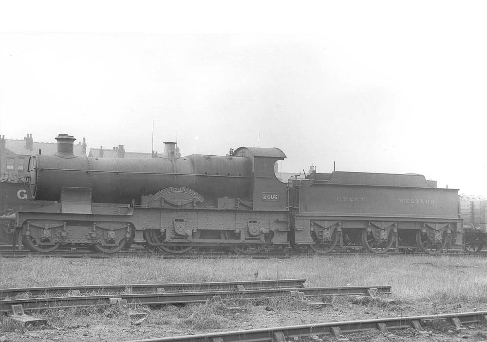 GWR 4-4-0 No 3403 'Trinidad', a Bulldog class outside-framed locomotive, is seen standing alongside the 'Loco' coal wagons