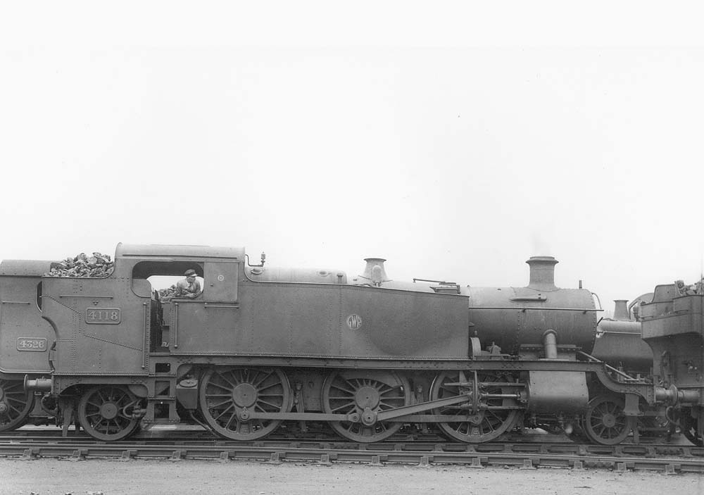 GWR No 4118, a class 51xx 'Large Prairie' locomotive, is seen in company with other locomotives waiting its turn to leave the shed