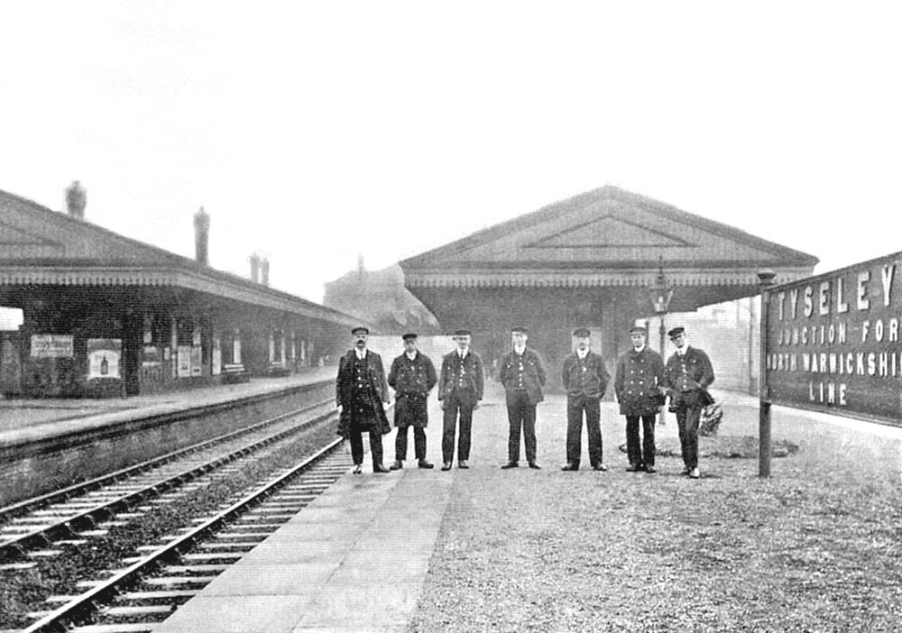 An Edwardian view of some of Tyseley station's staff posed on Platform 3 next to a revised station nameboard