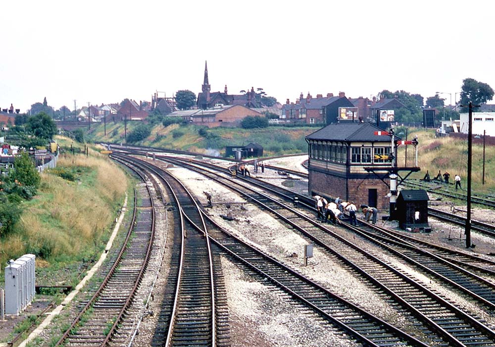 Looking towards London as a Permanent Way gang work on one of the crossovers on the up slow relief line on 17th August 1969