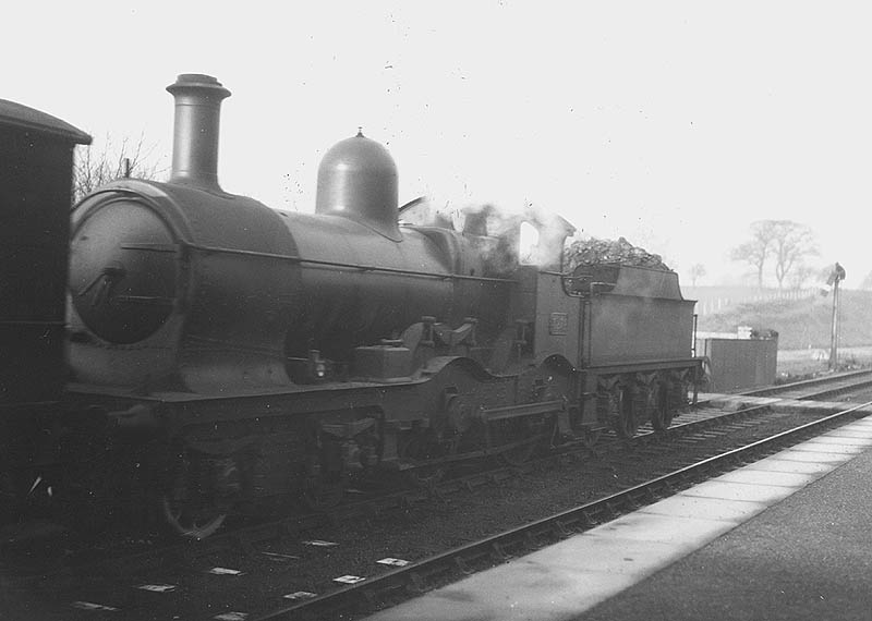 GWR 4-4-0 Duke class No 3274 'Newquay' with nameplate removed is seen running tender first on a down goods train as it passes through the station