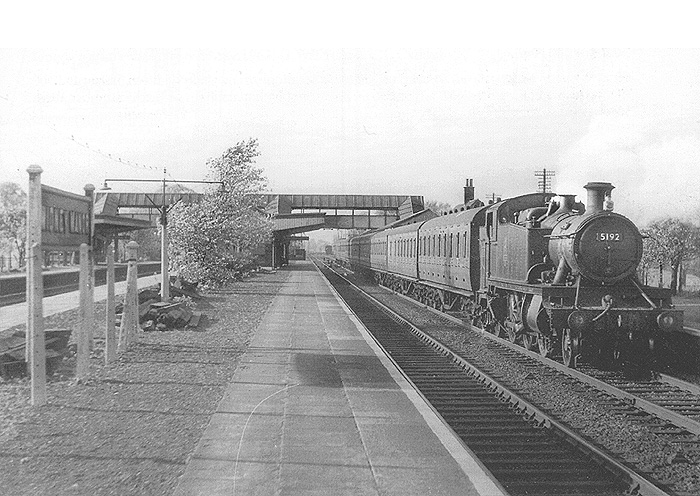 GWR 2-6-2T Large Prairie No 5192 is seen at the head of a long down local passenger train standing at the slow platform