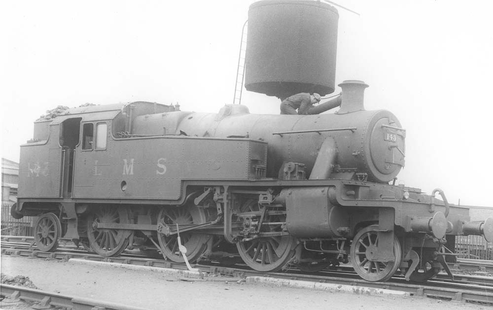 LMS 2-6-2T No 143 stands beneath the parachute water tank near the shed's entrance on 2nd July 1938