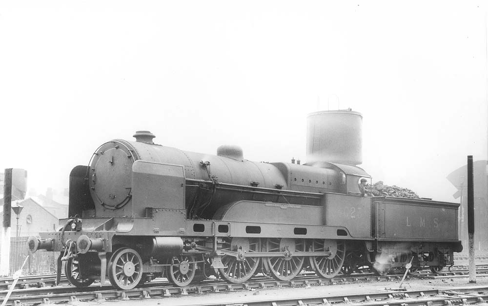 Ex-LNWR 4-6-0 'large boiler' Claughton class No 6023 'Sir Charles Oust' stands adjacent to the parachute water tank on 14th August 1937