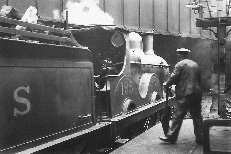 Midland Railway 1P 2-4-0 No 195 on pilot duties stands alongside the up face of Platform 5 adjacent to No2 Signal Cabin at the East end of the station