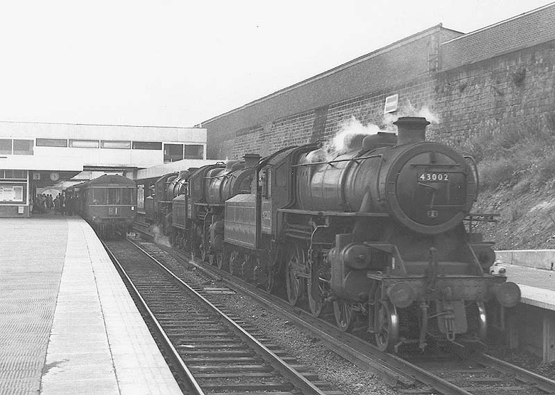 Ex-LMS 2-6-0 4MT No 43002 is seen in company with two other class mates standing at Coventry station's platform four