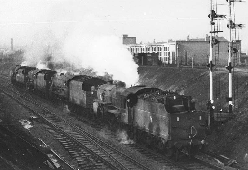 Ex-LMS 2-6-0 5MT 'Hughes Crab' No 42774 is seen running tender first towards Coventry station with three unidentified ex-LMS 2-8-0 8Fs in tow