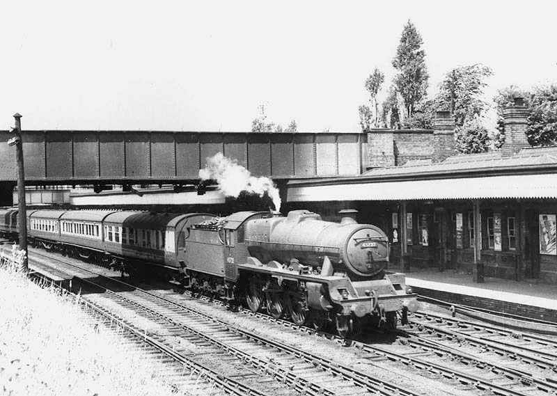 Ex-LMS 4-6-0 Jubilee class No 45722 'Defence' coupled to a Fowler 3500 gallon tender is seen passing through Coventry station at speed
