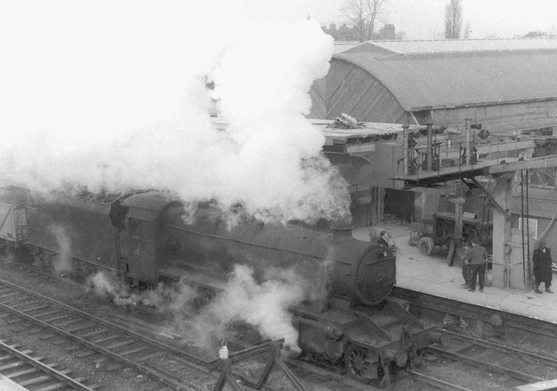 An unidentified ex-LMS 4-6-0 Stanier 'Black 5' is seen at the head of a mineral train as it passes through Coventry during the early stages of reconstruction