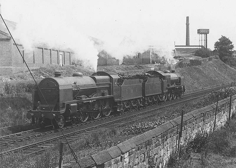 LMS 5XP Patriot class No 5519 'Lady Godiva' running tender first and coupled to an unknown classmate has just passed under Quinton Road bridge
