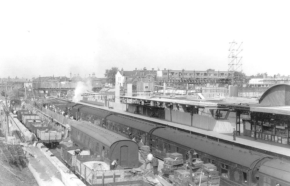 View of the excavation of platform 4 as passengers prepare to depart on a down express to New Street