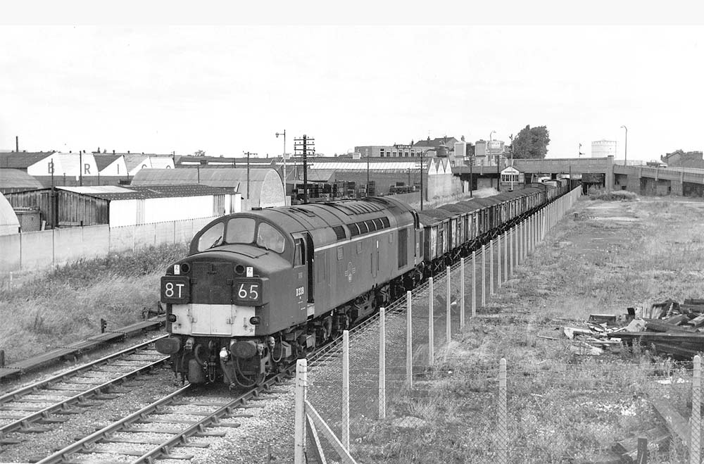 Looking towards Nuneaton as English Electric Type 4 No D339 passes the former site of Foleshill goods yard which has now been fenced off
