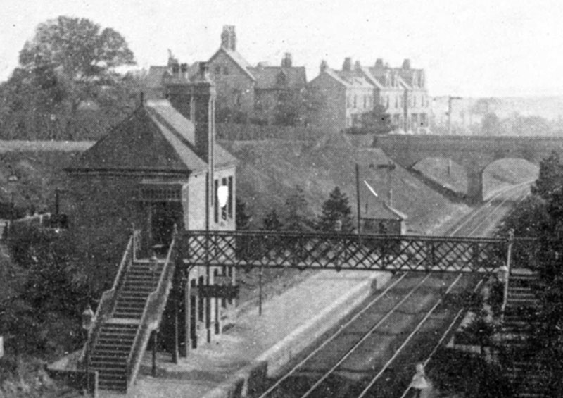 Close up showing the two-storey station building located on the Birmingham platform together with the signal cabin