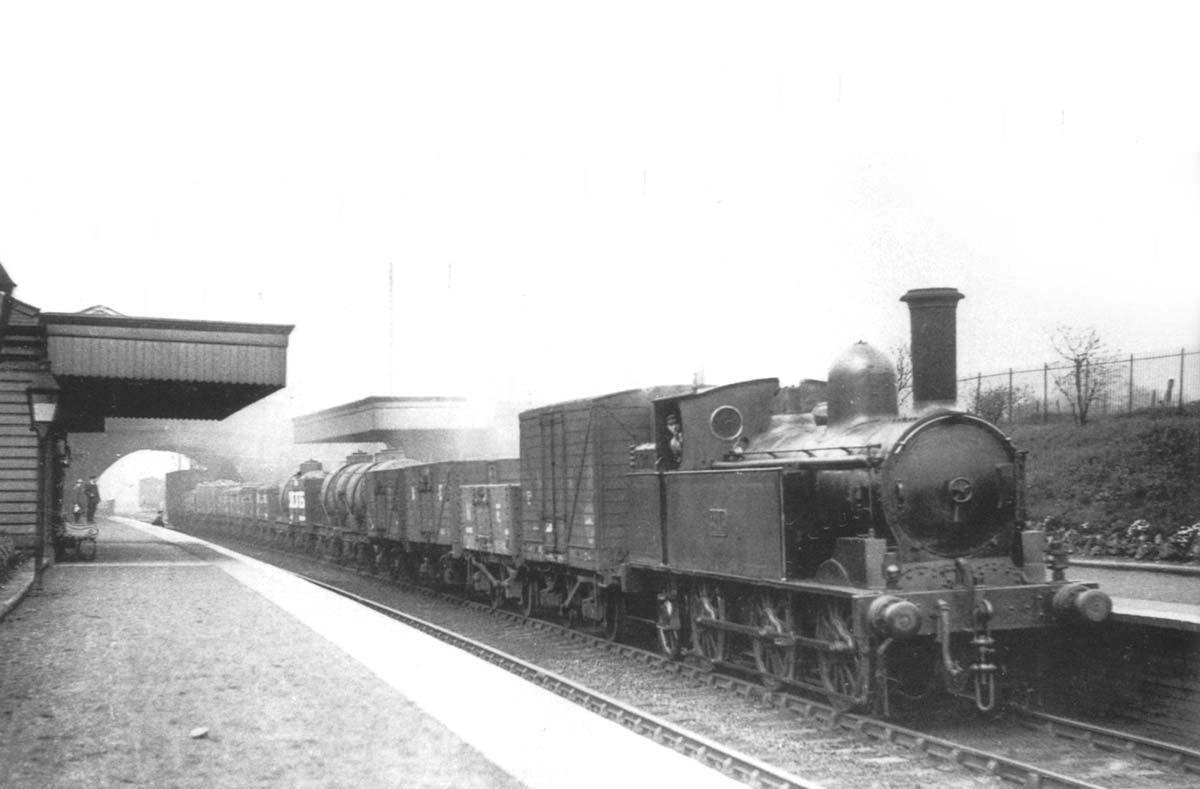 LNWR 0-6-2T 'Coal Tank' No 3715 trundles through Great Barr station whilst at the head of an up mixed freight from Bescot yard