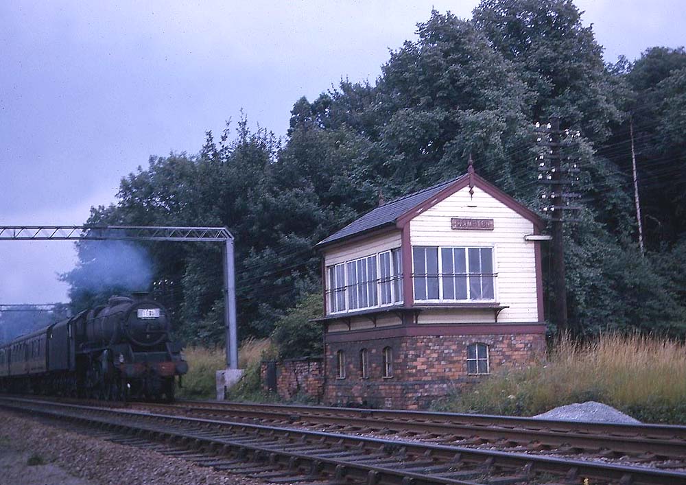 An unidentified ex-LMS 5MT 4-6-0 locomotive passes Hampton Signal Cabin which was sited opposite the former  B&DJR station on 8th August 1964
