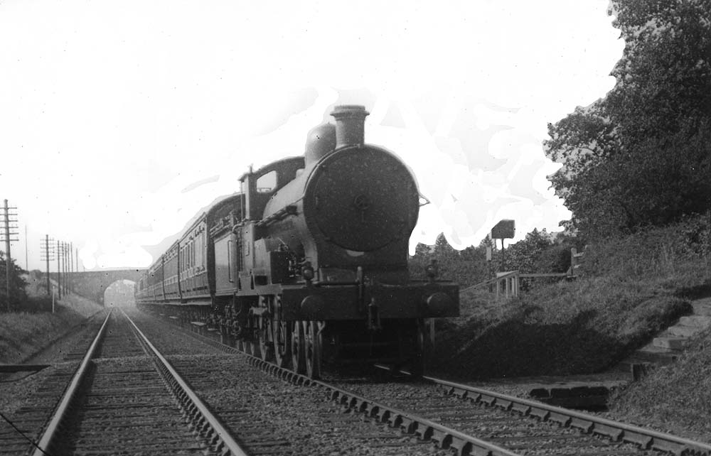 LNWR 3P George V class No 228 'E Nettlefild' is seen at the head of an up Birmingham to Euston express service in July 1921
