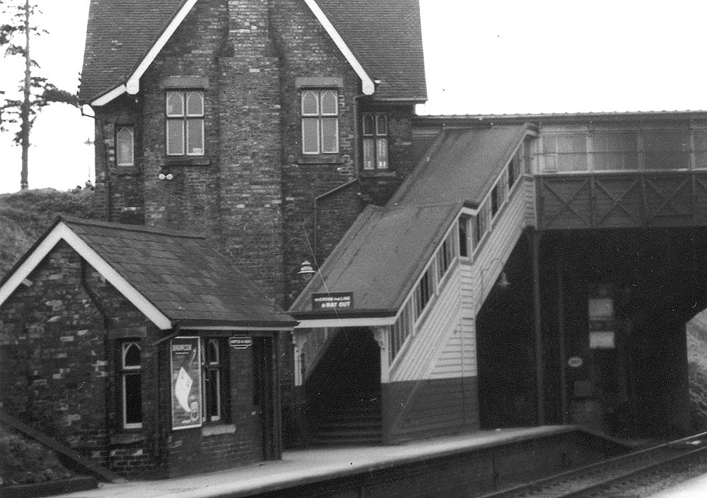 Close up showing the building on the down platform housing the station's gas oil and the passenger footbridge