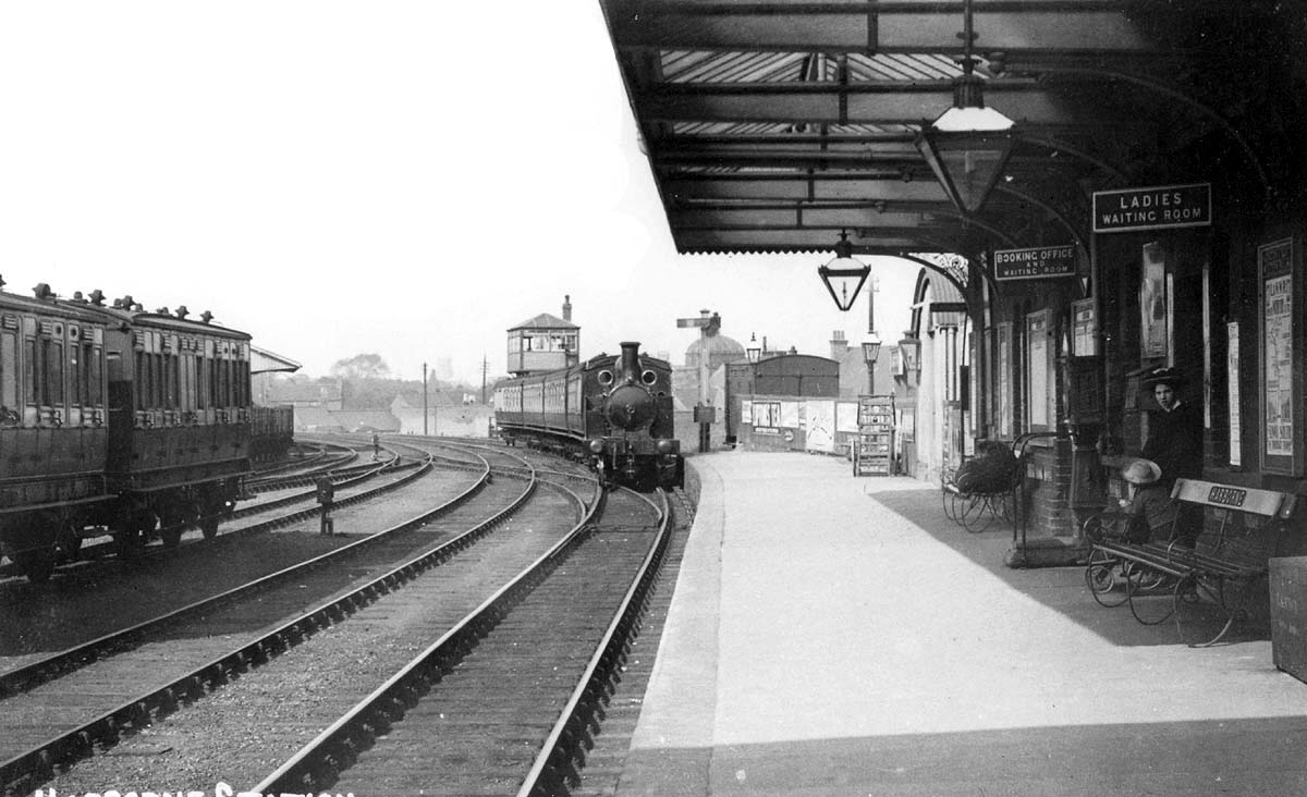 Looking towards Birmingham as a four-carriage commuter train arrives at Harbornes single platform terminus