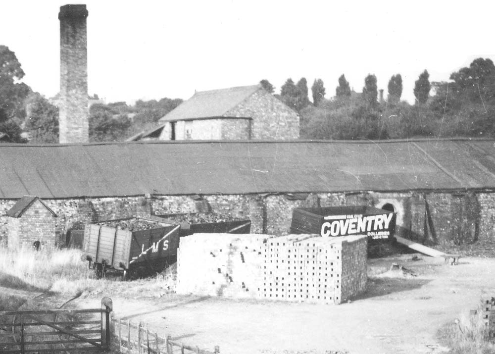 Close up showing seven plank railway wagons including a Coventry Colliery Private Owner vehicle in the yard of Cherry Orchard Brickworks