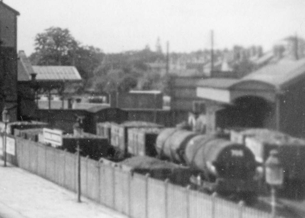 Close up of Kenilworth station's general goods yard and goods shed with an assortment of mineral wagons and oil tankers in the yard