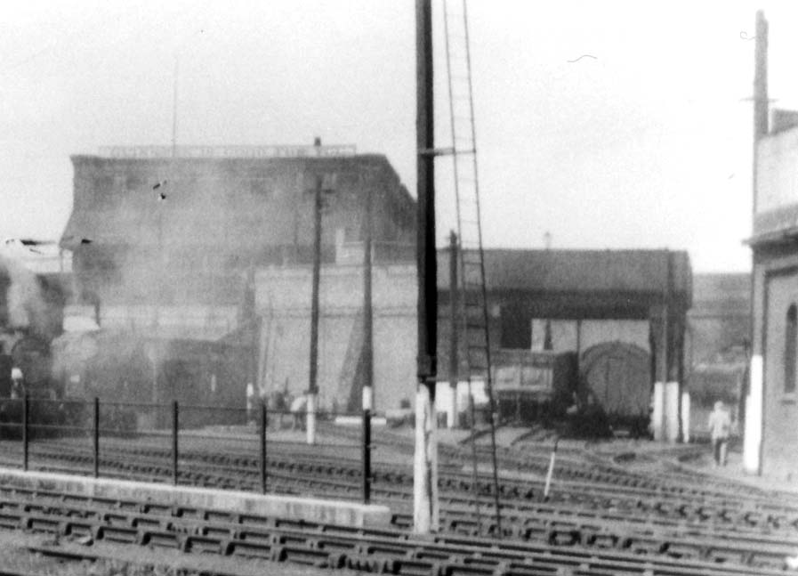 Close up showing the shed's former LNWR water tank with both of the coaling roads occupied by wagons