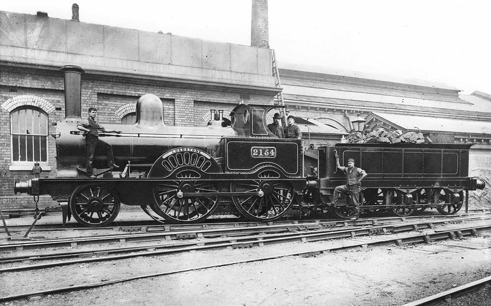 LNWR 2-4-0 Samson Class No 2154 'Loadstone' with its crew and two cleaners standing by the smokebox and the tender