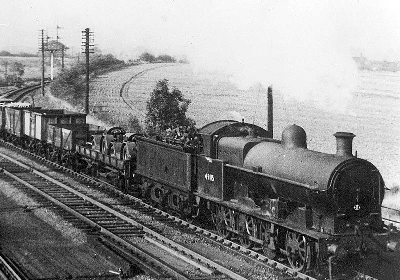 Ex-LNWR 0-8-0 class G2a No 49115 is seen on a class K trip pick up working as it passes the junction with Ashby on the slow line