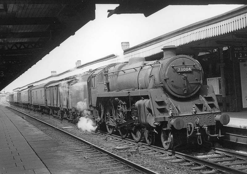 British Railways Standard class 5MT No 73004 is seen passing through platform four on a Class C up express goods service